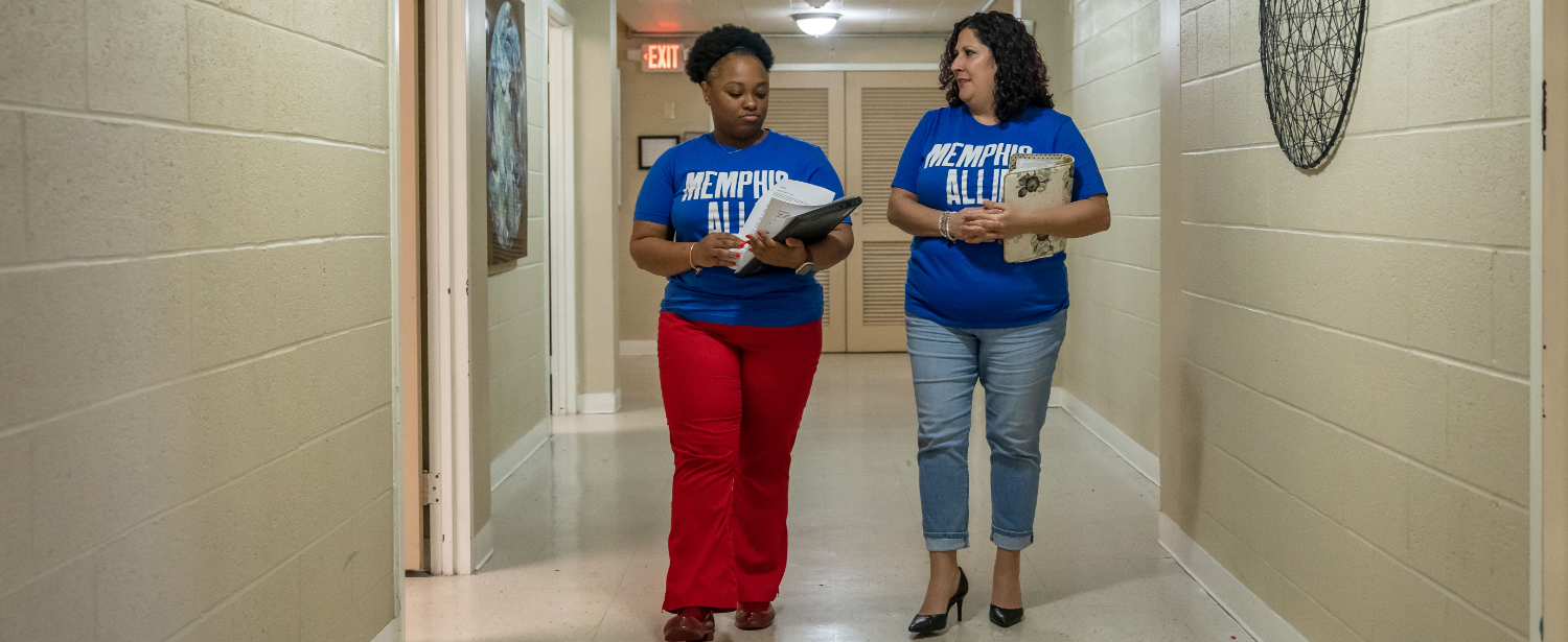 Christina Gann and Diamond walking in Memphis Allies office
